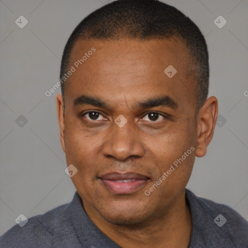 Joyful black adult male with short  brown hair and brown eyes