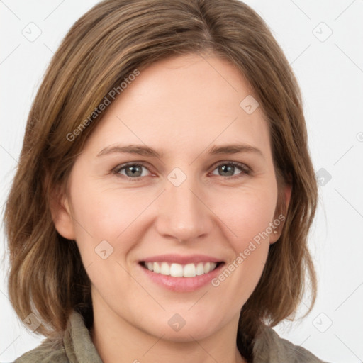 Joyful white young-adult female with medium  brown hair and green eyes