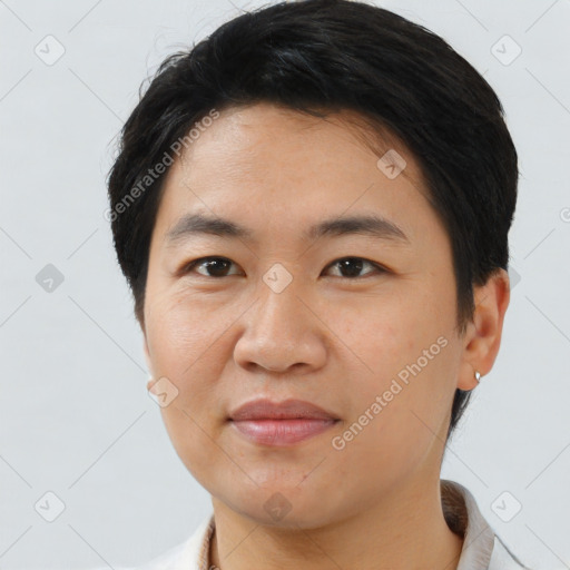 Joyful asian young-adult male with short  brown hair and brown eyes