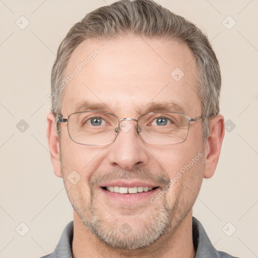 Joyful white adult male with short  brown hair and grey eyes