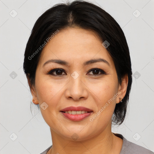 Joyful asian adult female with medium  brown hair and brown eyes