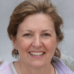 Joyful white adult female with medium  brown hair and blue eyes