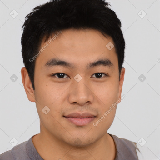 Joyful asian young-adult male with short  black hair and brown eyes