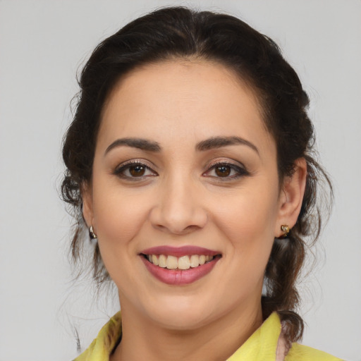 Joyful latino young-adult female with medium  brown hair and brown eyes