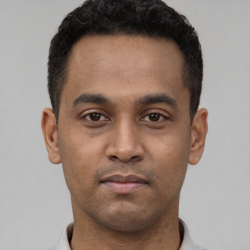 Neutral latino young-adult male with short  black hair and brown eyes