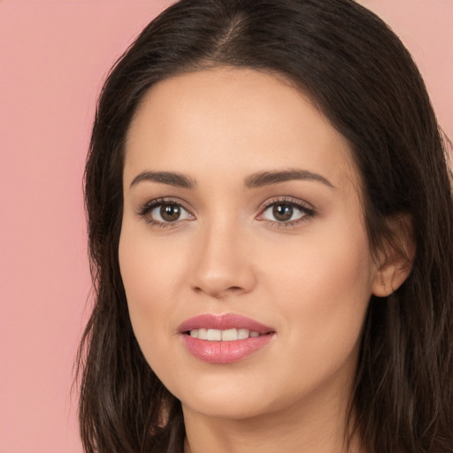 Joyful white young-adult female with long  brown hair and brown eyes