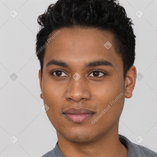 Joyful black young-adult male with short  black hair and brown eyes