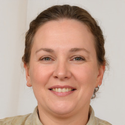 Joyful white adult female with short  brown hair and grey eyes