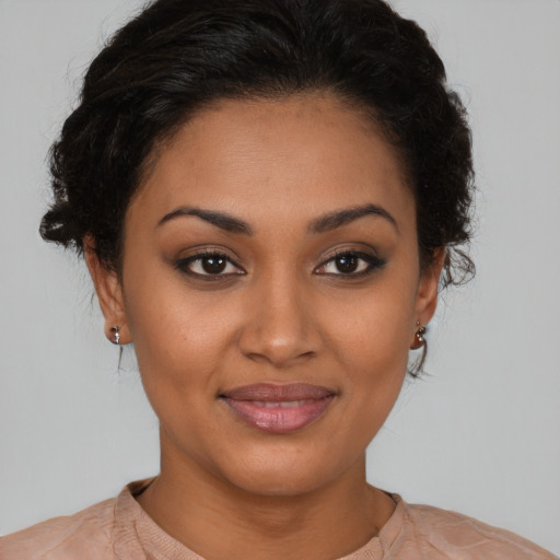 Joyful latino young-adult female with short  brown hair and brown eyes