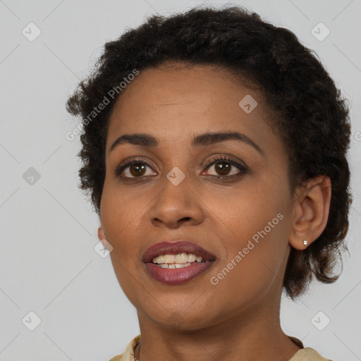 Joyful black young-adult female with short  brown hair and brown eyes