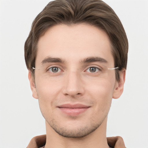 Joyful white young-adult male with short  brown hair and grey eyes