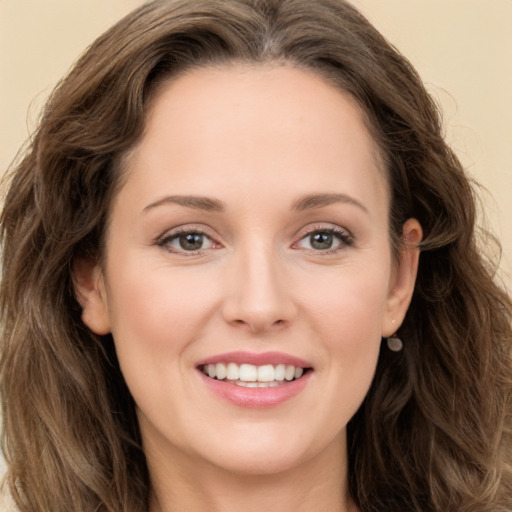 Joyful white young-adult female with long  brown hair and green eyes