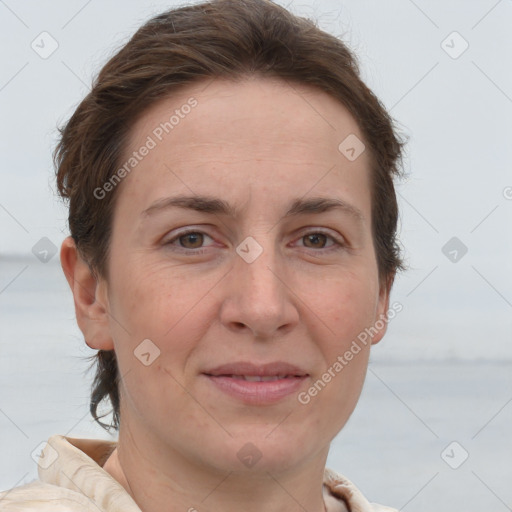 Joyful white adult female with short  brown hair and brown eyes