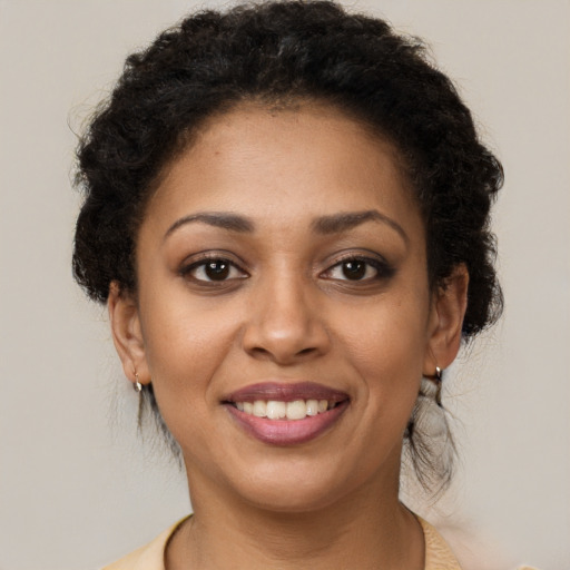 Joyful latino young-adult female with short  brown hair and brown eyes