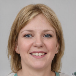 Joyful white young-adult female with medium  brown hair and blue eyes