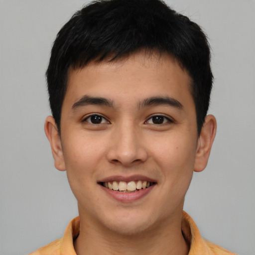 Joyful asian young-adult male with short  brown hair and brown eyes