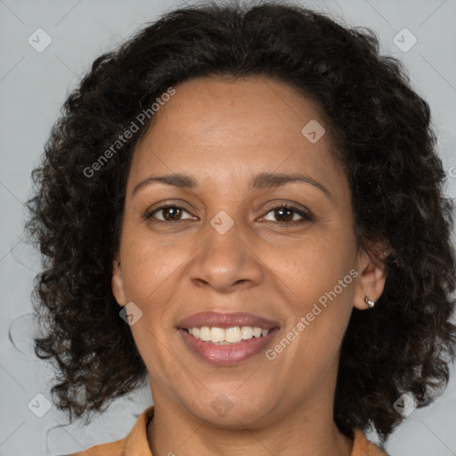 Joyful black adult female with medium  brown hair and brown eyes