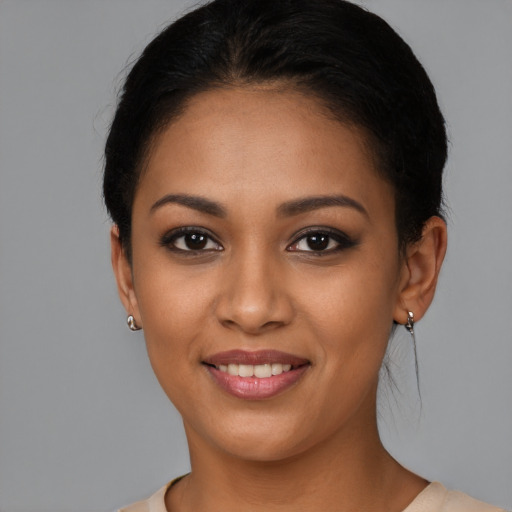 Joyful latino young-adult female with short  brown hair and brown eyes