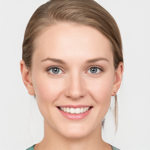 Joyful white young-adult female with medium  brown hair and blue eyes