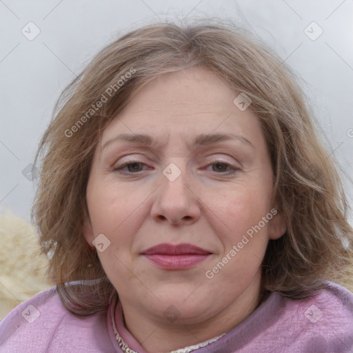 Joyful white adult female with medium  brown hair and blue eyes