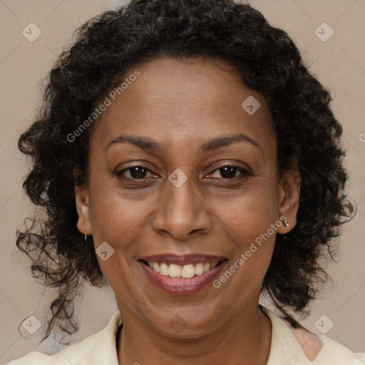 Joyful black adult female with medium  brown hair and brown eyes