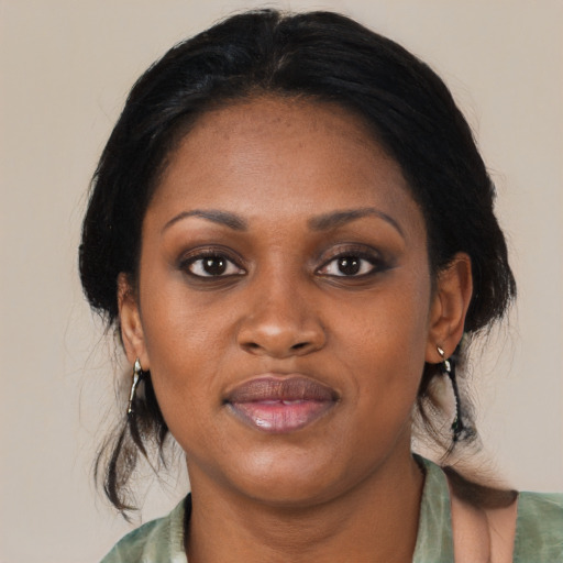 Joyful black young-adult female with medium  black hair and brown eyes
