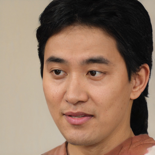 Joyful latino young-adult male with short  brown hair and brown eyes