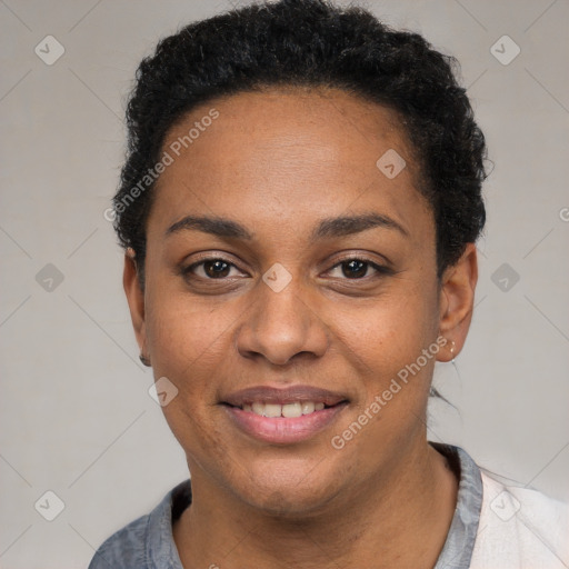 Joyful black young-adult female with short  black hair and brown eyes