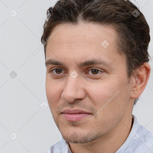 Joyful white adult male with short  brown hair and brown eyes