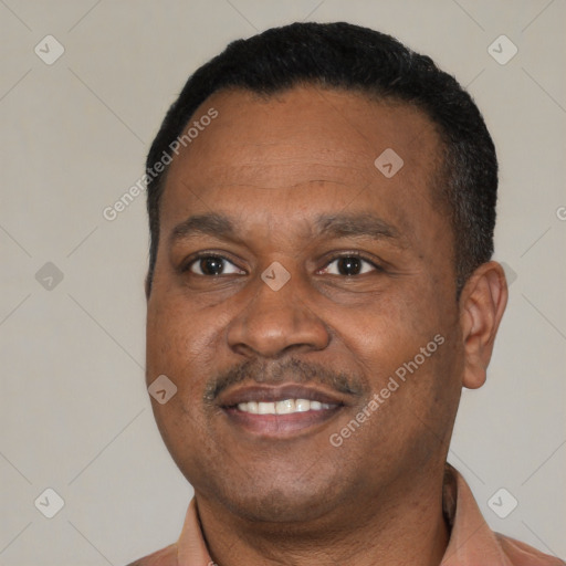 Joyful latino adult male with short  black hair and brown eyes