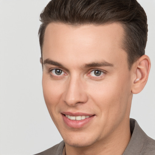 Joyful white young-adult male with short  brown hair and brown eyes