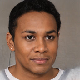 Joyful black young-adult male with short  brown hair and brown eyes