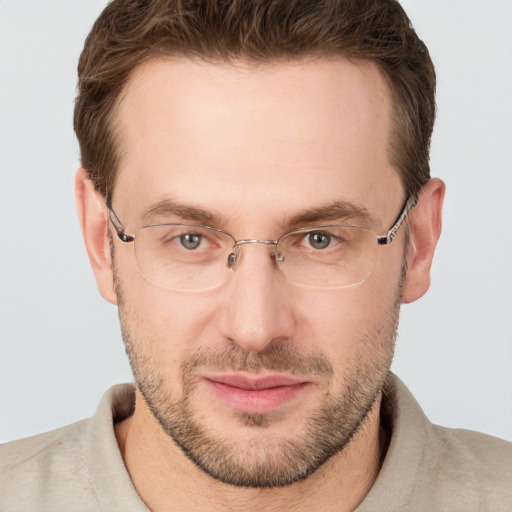 Joyful white adult male with short  brown hair and grey eyes