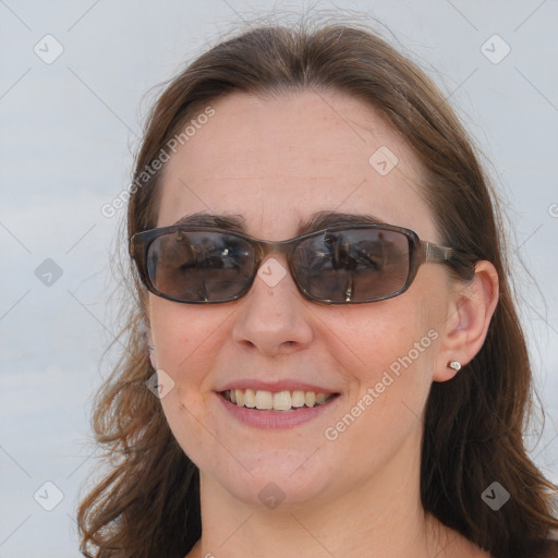 Joyful white adult female with medium  brown hair and blue eyes