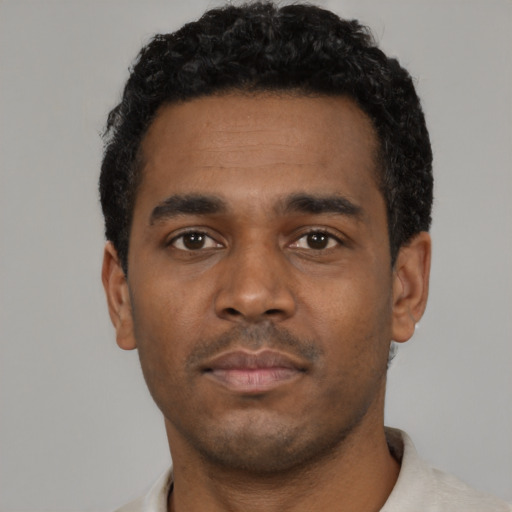 Neutral black young-adult male with short  black hair and brown eyes