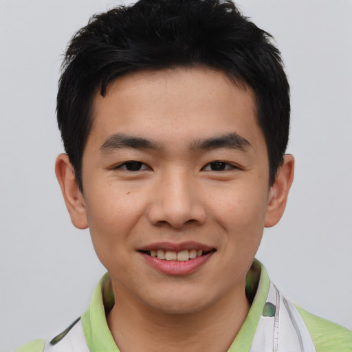 Joyful asian young-adult male with short  brown hair and brown eyes