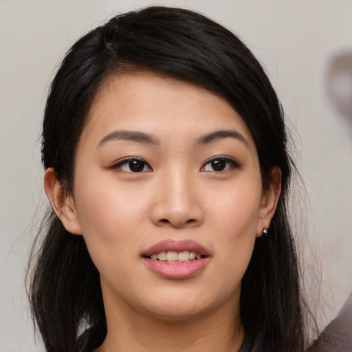 Joyful asian young-adult female with long  black hair and brown eyes