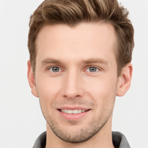 Joyful white young-adult male with short  brown hair and grey eyes