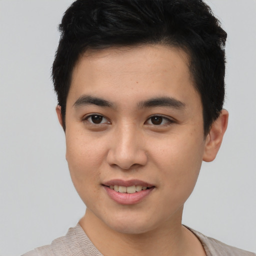 Joyful asian young-adult male with short  brown hair and brown eyes