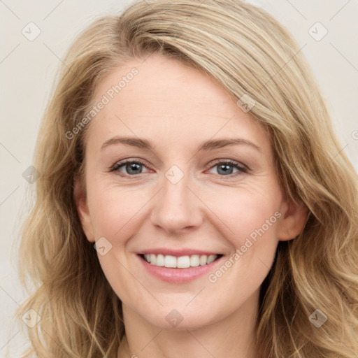 Joyful white young-adult female with long  brown hair and blue eyes