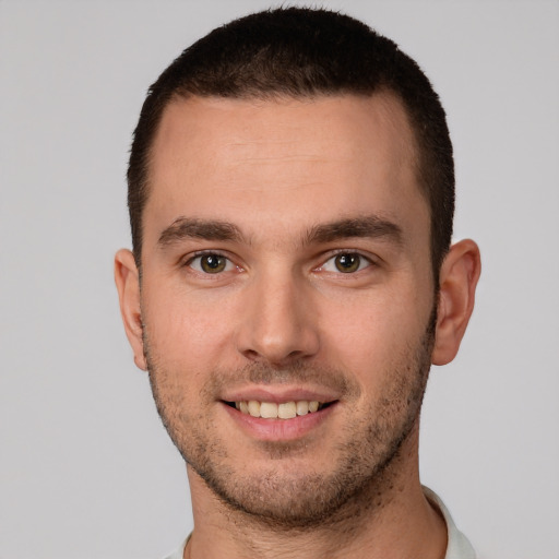 Joyful white young-adult male with short  brown hair and brown eyes