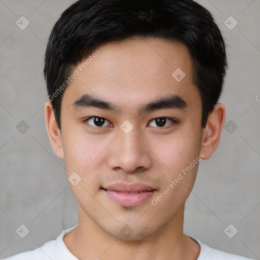 Joyful asian young-adult male with short  brown hair and brown eyes