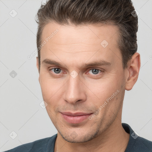 Joyful white young-adult male with short  brown hair and brown eyes