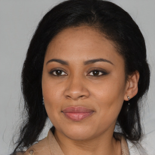 Joyful latino young-adult female with medium  black hair and brown eyes