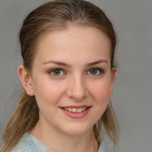 Joyful white young-adult female with medium  brown hair and blue eyes