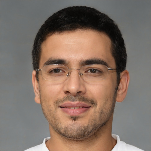 Joyful latino young-adult male with short  black hair and brown eyes