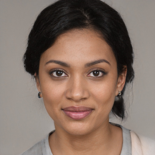 Joyful black young-adult female with medium  black hair and brown eyes