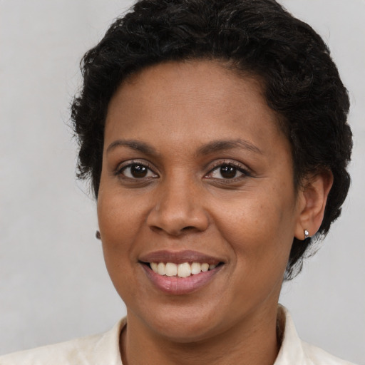 Joyful latino adult female with short  brown hair and brown eyes