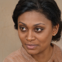 Joyful black young-adult female with medium  brown hair and brown eyes