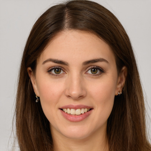 Joyful white young-adult female with long  brown hair and brown eyes